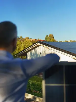Proud homeowner inspects their new home solar installation